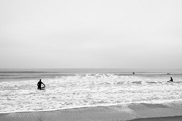 4 surfers gaan de zee in - Zwart wit - Den Haag van Tim als fotograaf