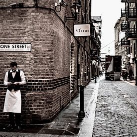 Kelner in historische straat in London van Francisca Snel