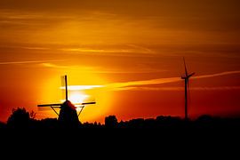 An old and new Windmill with a sunset by Jan Hermsen