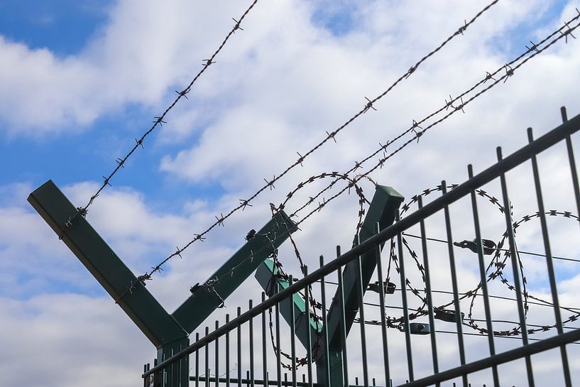 Close up of barbed wire on border fence by MPfoto71