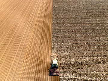 Tractor preparing the soil for planting crops by Sjoerd van der Wal Photography