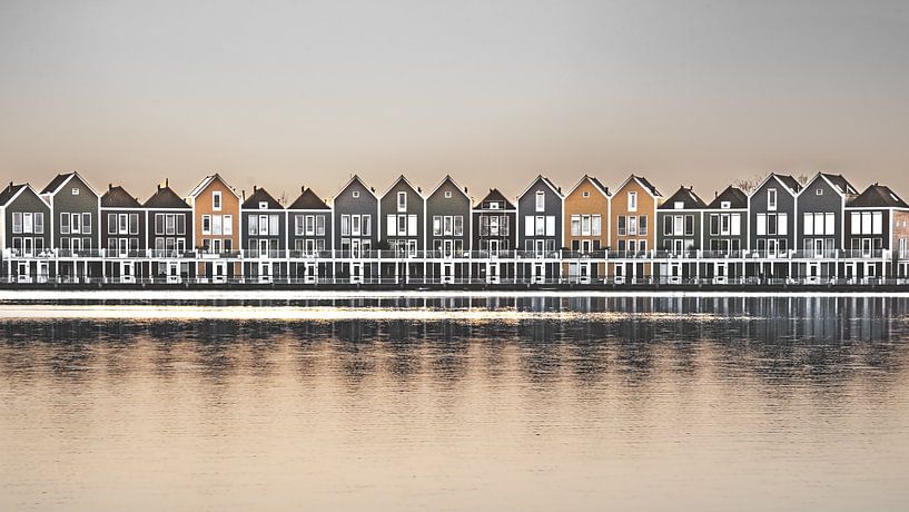 Serene tranquility by a lake with wooden houses by Jan Hermsen