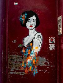 Graffiti of colourful lady on a door by Maarten Leeuwis