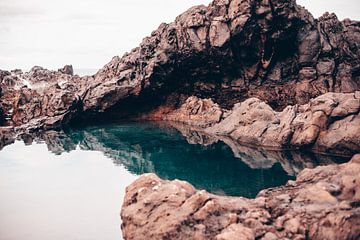 Rock reflection in the blue sea in Tenerife by Madinja Groenenberg