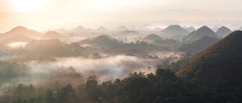 Panorama Chocolate Hills on Bohol Island in the Philippines at sunrise with fog in the valley
