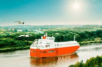 Ship on Kiel Canal backlit in beautiful landscape