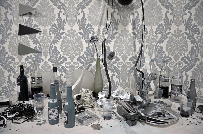 Black and white still life with different bottles of liquor and garlands by Gert Bunt