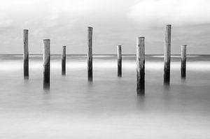 Beach posts in the sea by Mark Bolijn