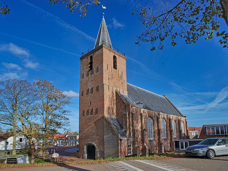 Die Nicolaaskirche in Kortgene vor einem sonnigen Hintergrund von Gert van Santen