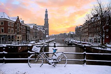 Amsterdam covered with snow with the Westerkerk in winter in the