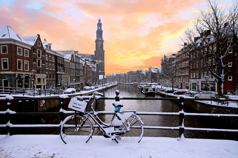 Amsterdam covered with snow with the Westerkerk in winter in the von Eye on You