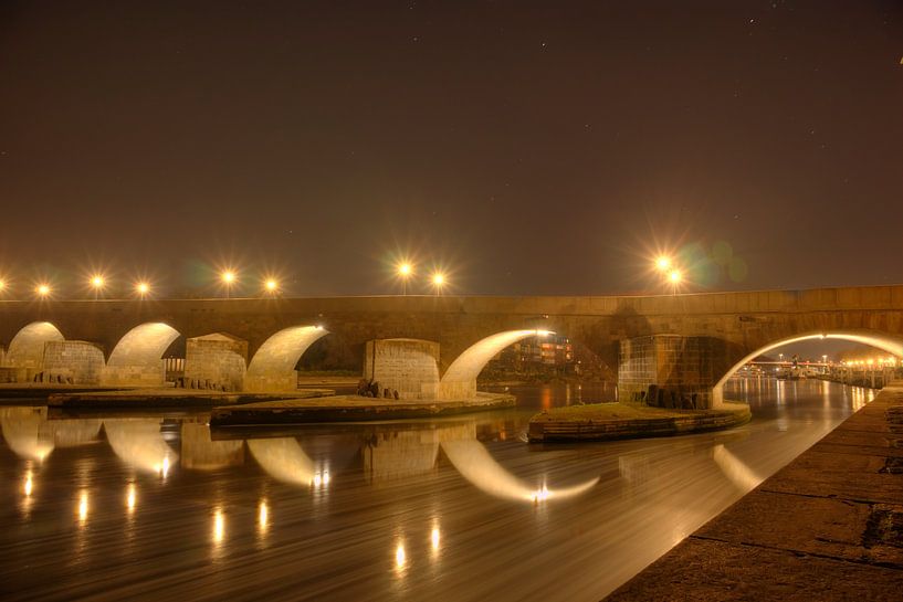 Stone bridge to Regensburg at night by Roith Fotografie