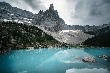 Mountain lake with view of the Dolomites by road to aloha