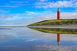 Texel lighthouse at the beach during a calm autumn afternoon wit