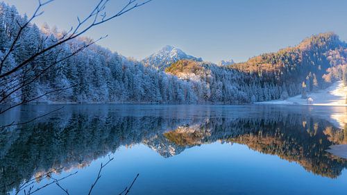 Frosty Mountains mirroring in the Alatsee in Bavaria Allgaeu Germany with great sunny Winter Vibes