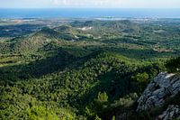 Uitzicht van Sant Salvador (Mallorca) naar het heuvelachtige landschap met de zee op de achtergrond