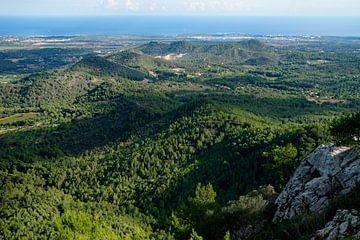 Blick von Sant Salvador (Mallorca) auf die hügelige Landschaft mit dem Meer im Hintergrund