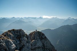 Climbers on the summit of the Aggenstein with a view of the Tannheimer Valley and the Allgäu Alps, including the Hochvogel