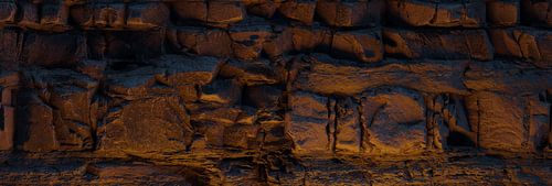 a rock face made up of layered strata, illuminated by the campfire by Besa Art
