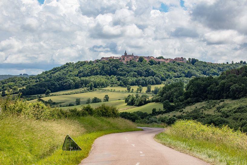 View and village on a hill in Bourgogne , France by Joost Adriaanse