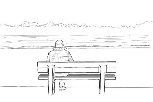 Homme sur un banc sur la plage