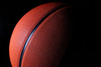 Close-up of a basketball against a black background