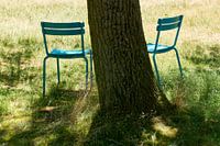 Chairs in field