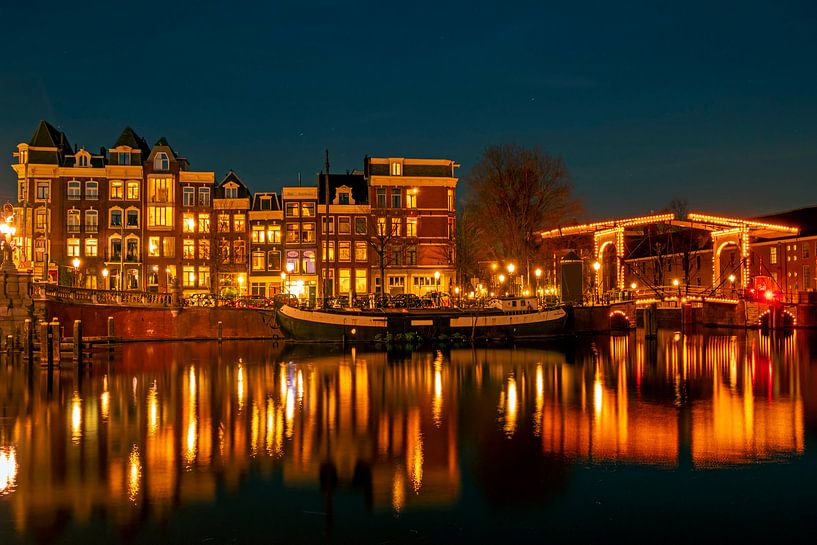 Amsterdam on the Amstel at night in the Netherlands by Eye on You