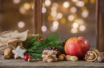 Red apple with christmas decoration on wood table by Alex Winter