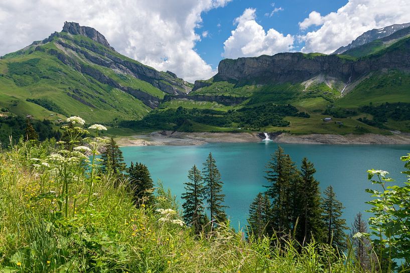 Blue mountain lake with green mountains and waterfall by Linda Schouw