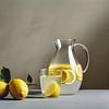 Refreshing Still Life - Lemons and Water Jug on Grey Background by Roger VDB