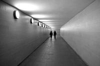 Black-and-white photo of a corridor with 2 silhouettes