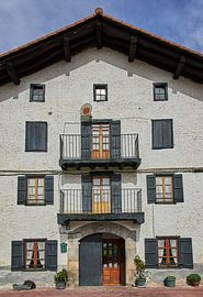 Façade with old satellite dish and modern door behind century-old entrance by Ton Van Zeijl