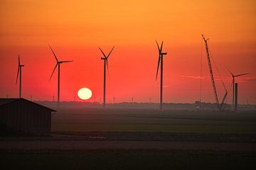 sunset near a wind farm under construction by PixelPower