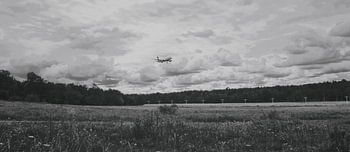 An airplane into a black and white atmosphere