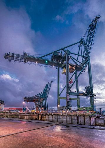 Twilight scene with container crane against dramatic sky, Antwerp 
