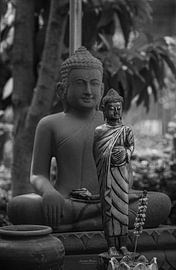 Two Buddha statues in front of each other by Laurie Bosman