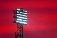 Top light pole of De Kuip during evening red