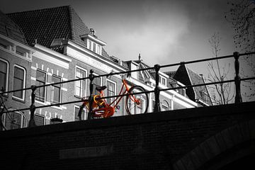 Orange Bike on bridge by Jasper Hovenga
