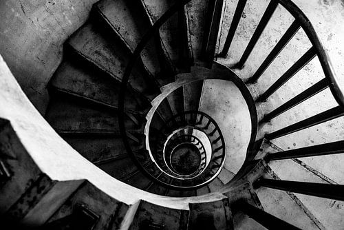 Black and white urban spiral staircase down.