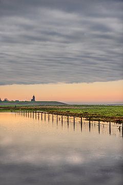 The Wadden dike with the church of the Frisian village of Wierum by Harrie Muis