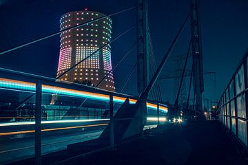 Long Exposure of passing bus with illuminated cooling tower by Daan Duvillier