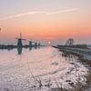 Sunrise windmills Kinderdijk in winter by Mark den Boer