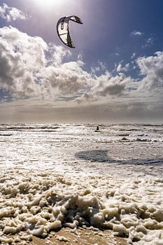 Kitesurfer on raging sea with tile light