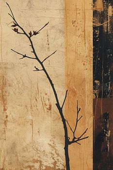 Ein zerbrechlicher Zweig kontrastiert mit verwitterten Erdtönen