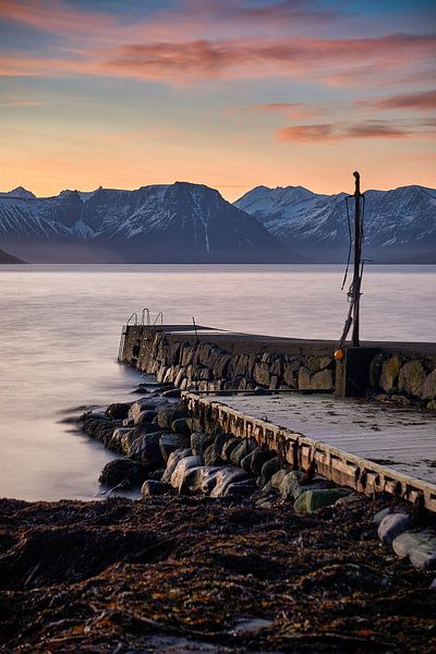 Winter landscape with sunset and pier on Godøy, Ålesund, Norway by qtx