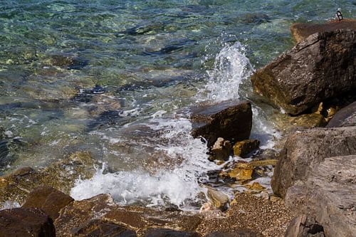 Zee, rotsen en opspattende golf