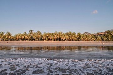 Beach with palm trees in Costa Rica by Bianca Kramer