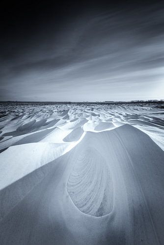Snowdunes in the National Park Lauwersmeer in Groningen after a snowstorm in black and white. The be