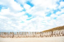 Poles on the beach of Domburg. by Ron van der Stappen